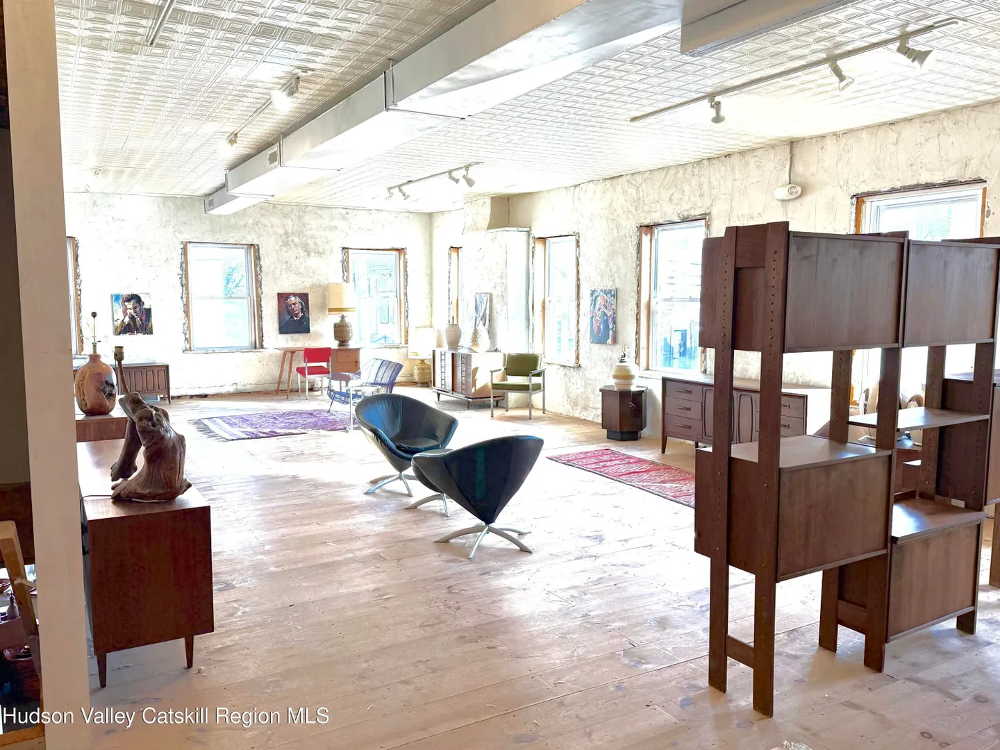 Bright upper commercial gallery with high ceilings
