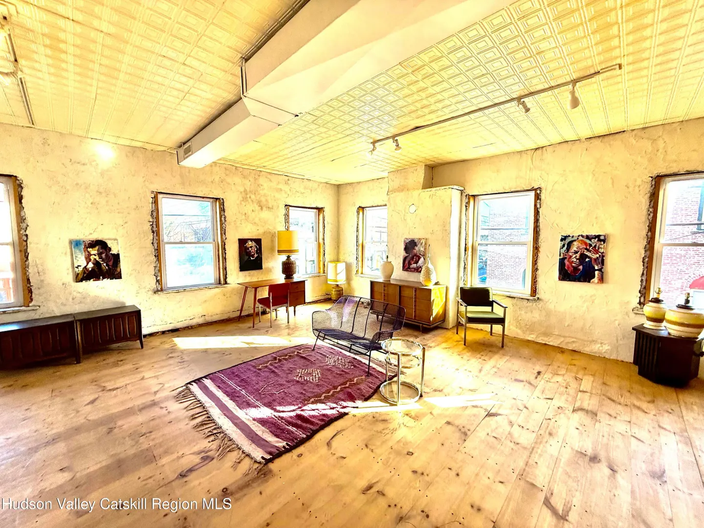 Upper gallery showing wood floors and exposed ceiling